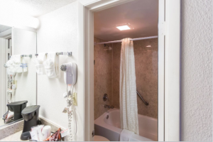 A bathroom featuring a shower/tub combo and more at the Maingate Lakeside Resort located near Disney World